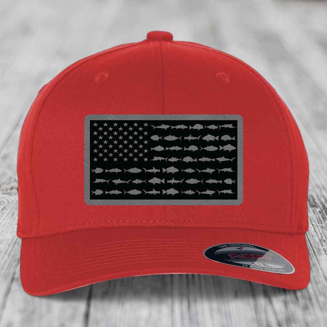 Red baseball cap with black American flag patch featuring fish silhouettes instead of stars and stripes.