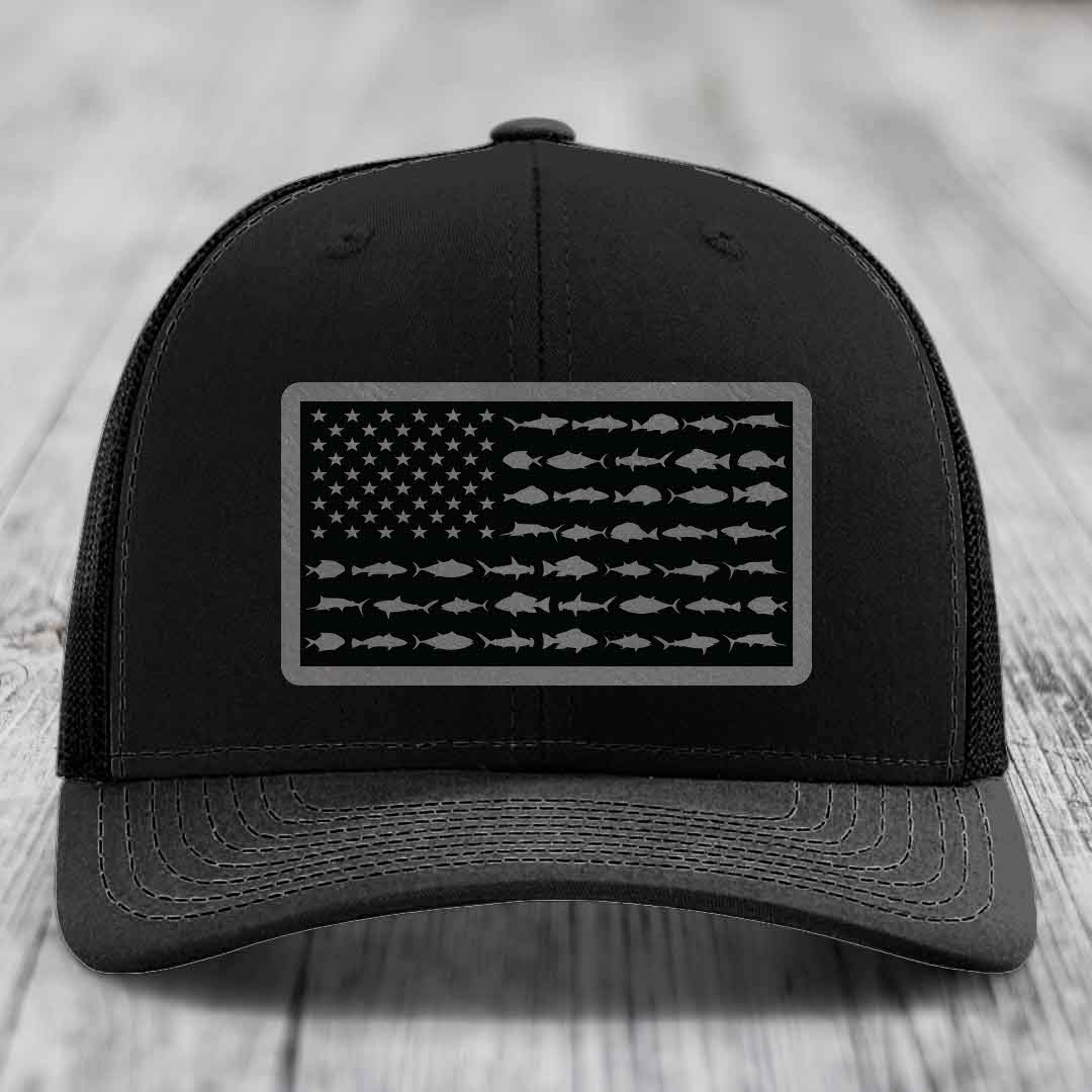 Black trucker hat with American flag patch made of saltwater fish silhouettes.