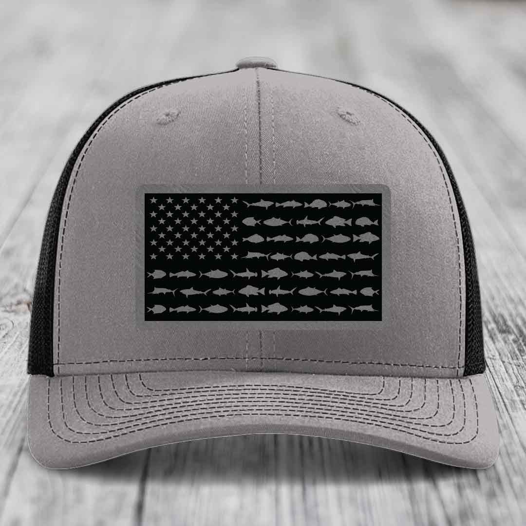 Grey trucker hat with black American flag patch featuring fish silhouettes instead of stars and stripes.