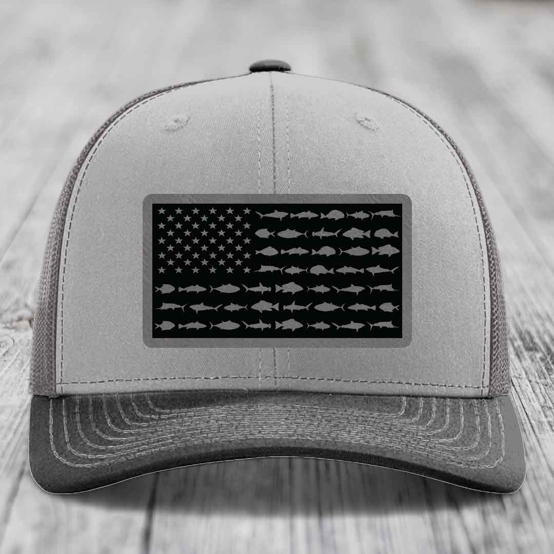 Grey trucker hat with black American flag patch featuring fish silhouettes instead of stars and stripes.