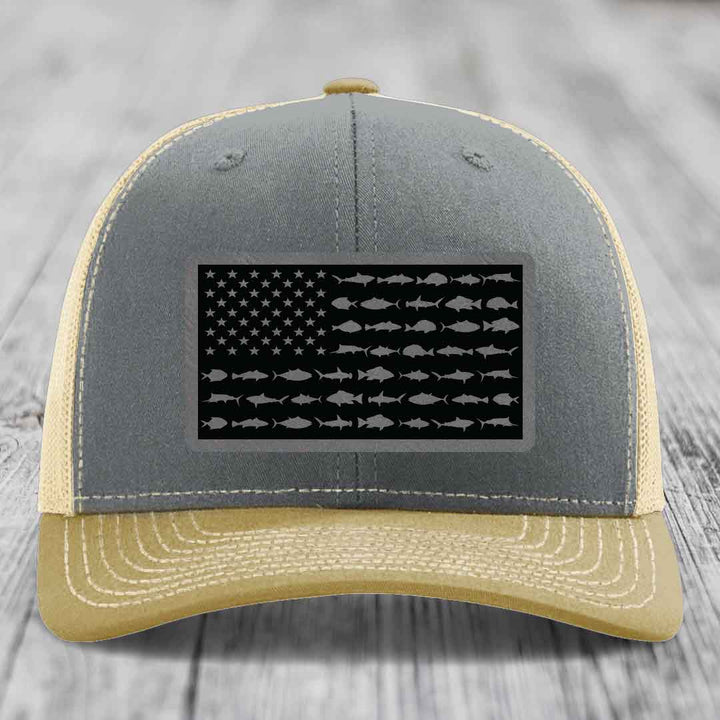 Grey and beige trucker hat with American flag patch made of saltwater fish silhouettes.