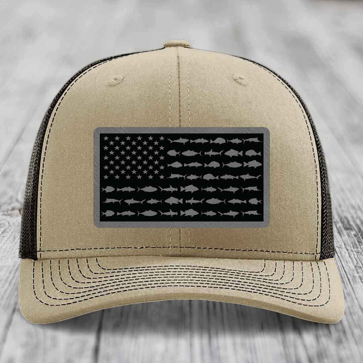 Beige trucker hat with black mesh back, featuring a rectangular patch of an American flag made of fish silhouettes.