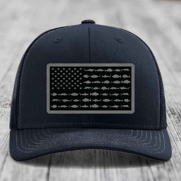Black trucker hat with American flag patch made of saltwater fish silhouettes.