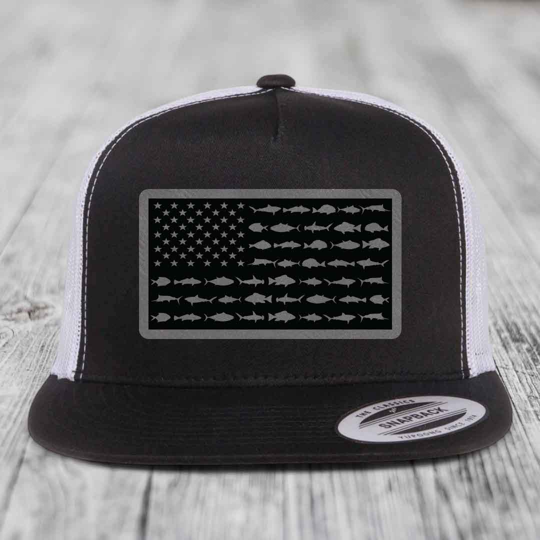 Black and white trucker hat with American flag patch made of saltwater fish silhouettes.