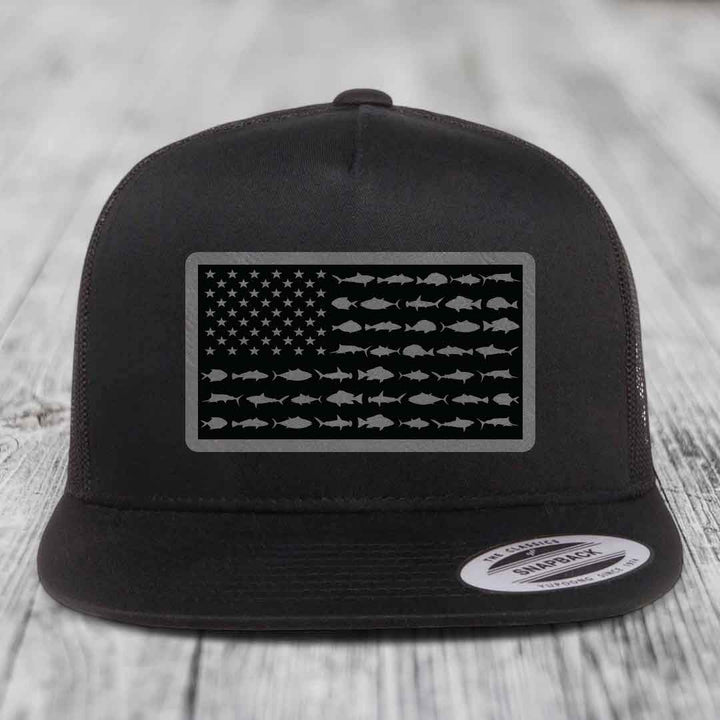Black trucker hat with American flag patch made of saltwater fish silhouettes.