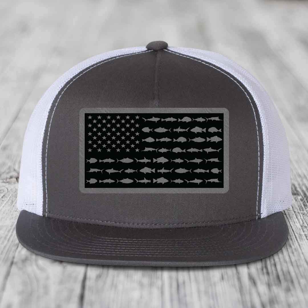 Black and white trucker hat with American flag patch made of saltwater fish silhouettes.