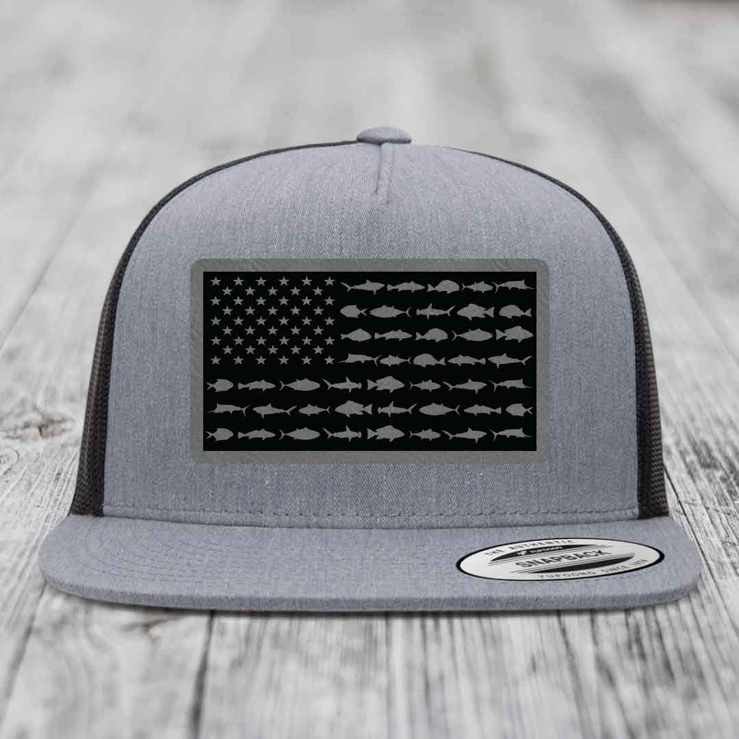 Grey trucker hat with black American flag patch featuring fish silhouettes instead of stars and stripes.