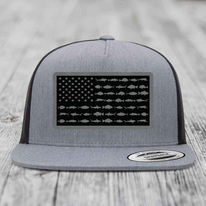 Grey trucker hat with black American flag patch featuring fish silhouettes instead of stars and stripes.
