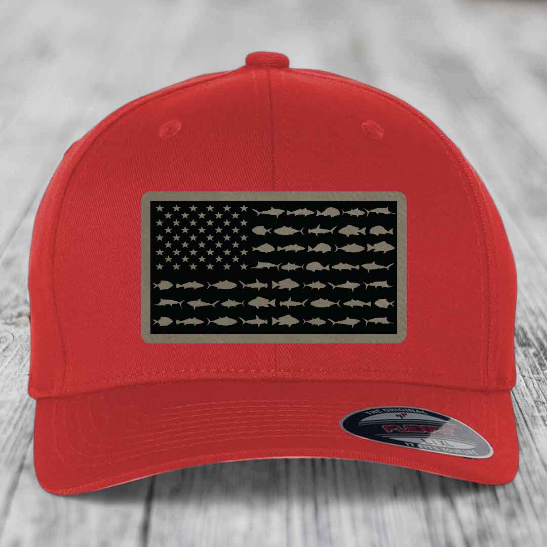 Red baseball cap with American flag patch featuring fish silhouettes instead of stars and stripes.