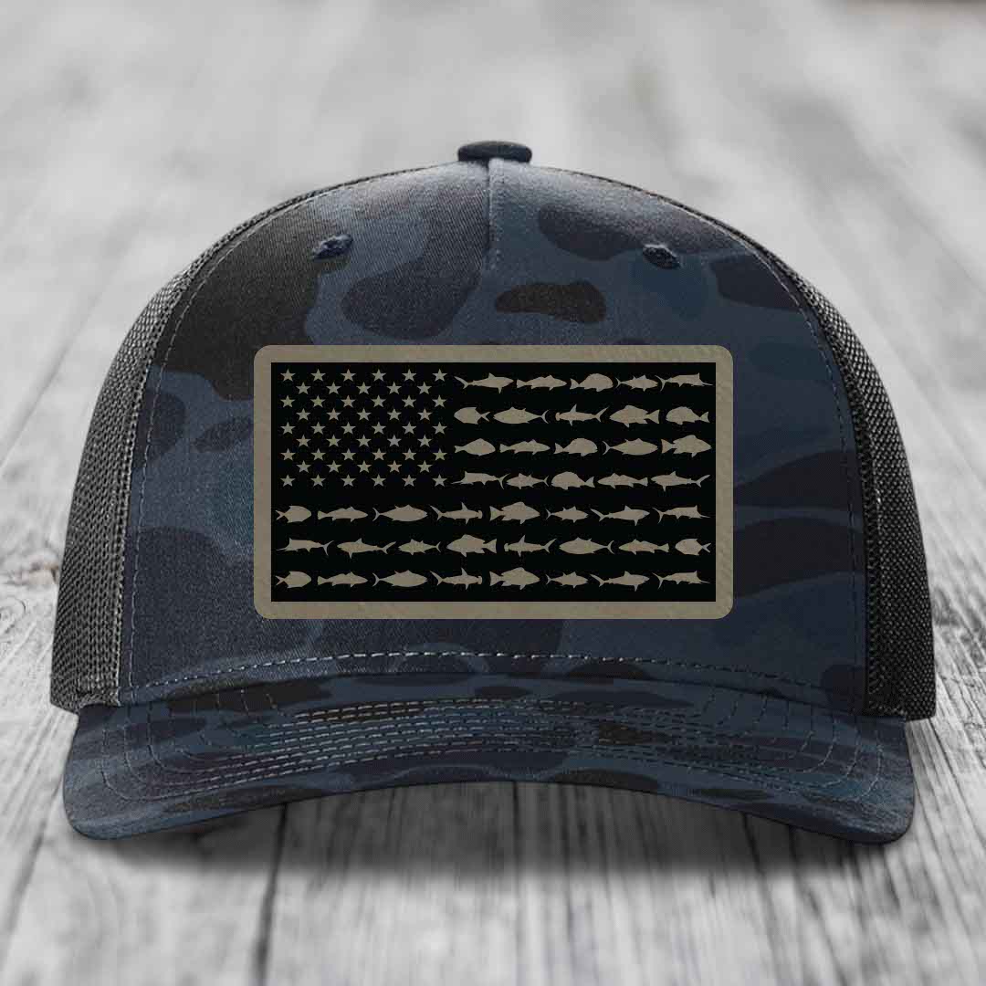 Camouflage trucker hat with American flag patch made of saltwater fish silhouettes.