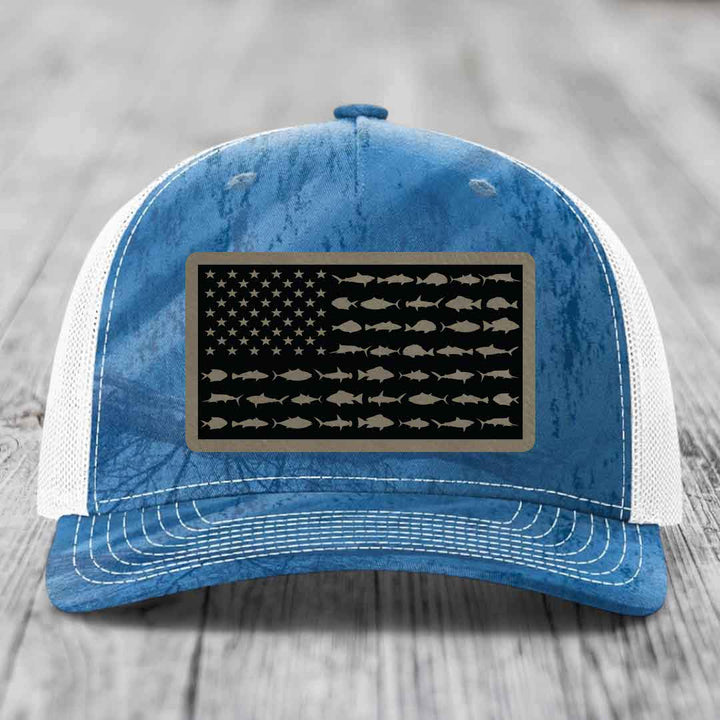 Blue and white trucker hat with a saltwater fish flag patch on the front.