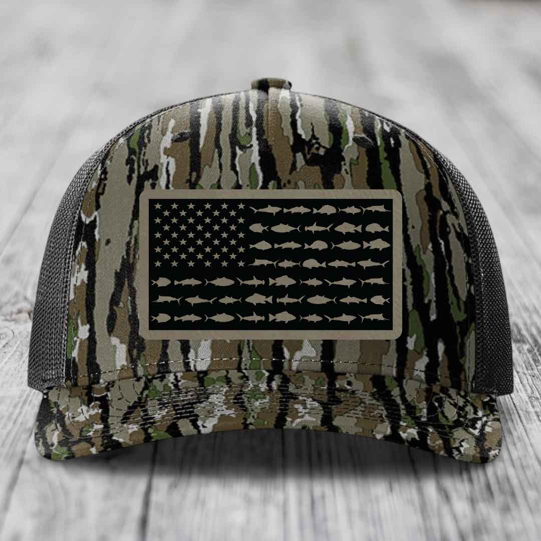 Camouflage trucker hat with American flag patch featuring saltwater fish silhouettes instead of stars and stripes.