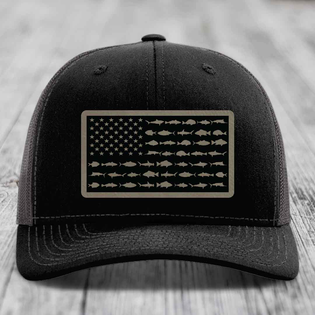 Black trucker hat with American flag patch made of saltwater fish silhouettes.