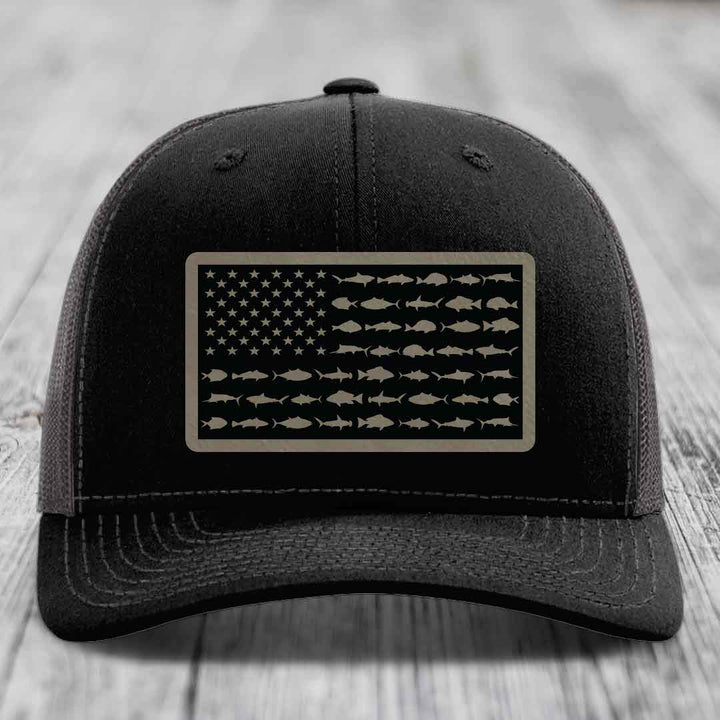 Black trucker hat with American flag patch made of saltwater fish silhouettes.