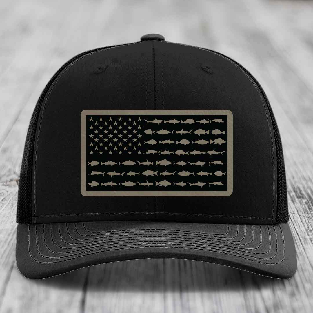 Black trucker hat with American flag patch made of saltwater fish silhouettes.