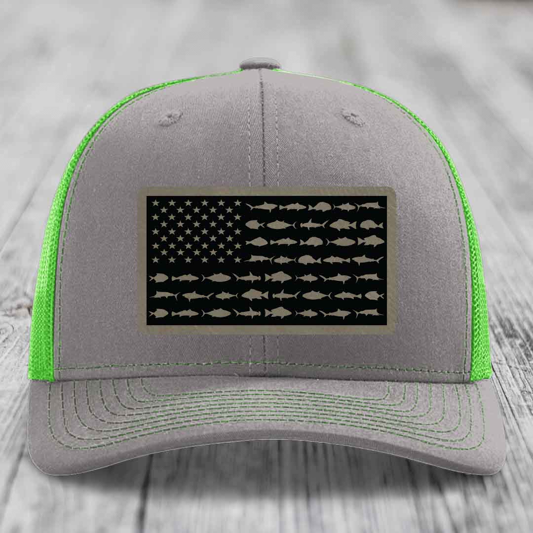 Grey trucker hat with neon green mesh and stitching, featuring a saltwater fish flag patch.