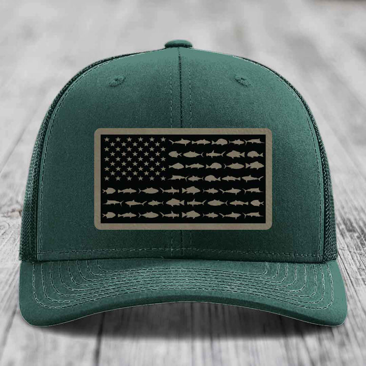 Green trucker hat with American flag patch made of saltwater fish silhouettes.