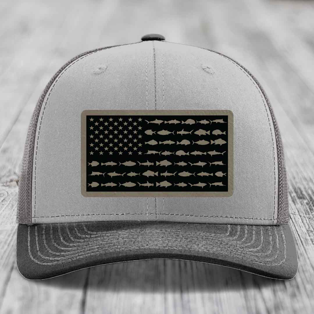 Grey trucker hat with black American flag patch featuring fish silhouettes instead of stars and stripes.