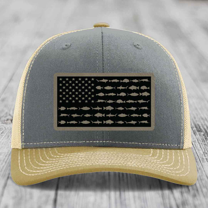 Grey and beige trucker hat with American flag patch made of saltwater fish silhouettes.