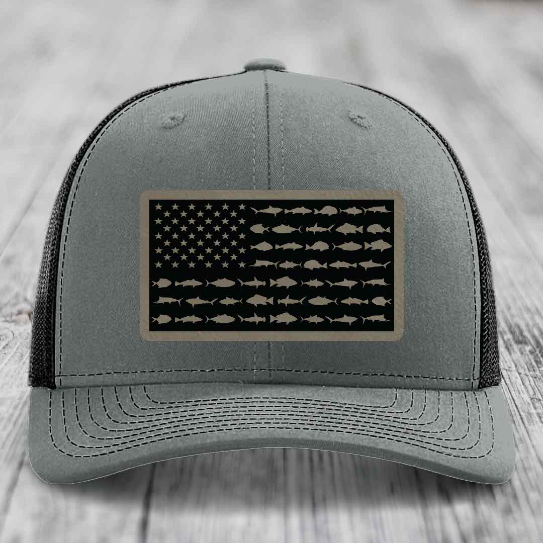 Grey trucker hat with black mesh back and a rectangular patch featuring an American flag design made of fish silhouettes.