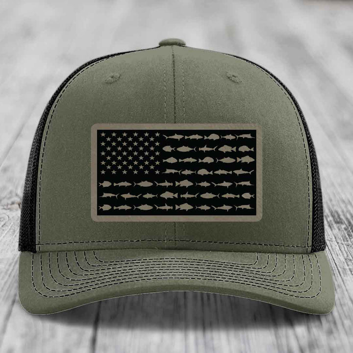 Olive green trucker hat with American flag patch made of saltwater fish silhouettes.