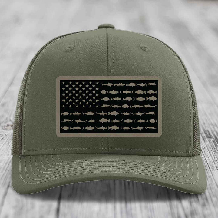 Olive green trucker hat with American flag patch made of saltwater fish silhouettes.