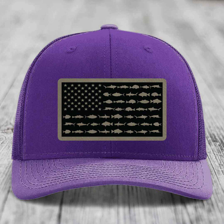 Purple trucker hat with American flag patch made of saltwater fish silhouettes.