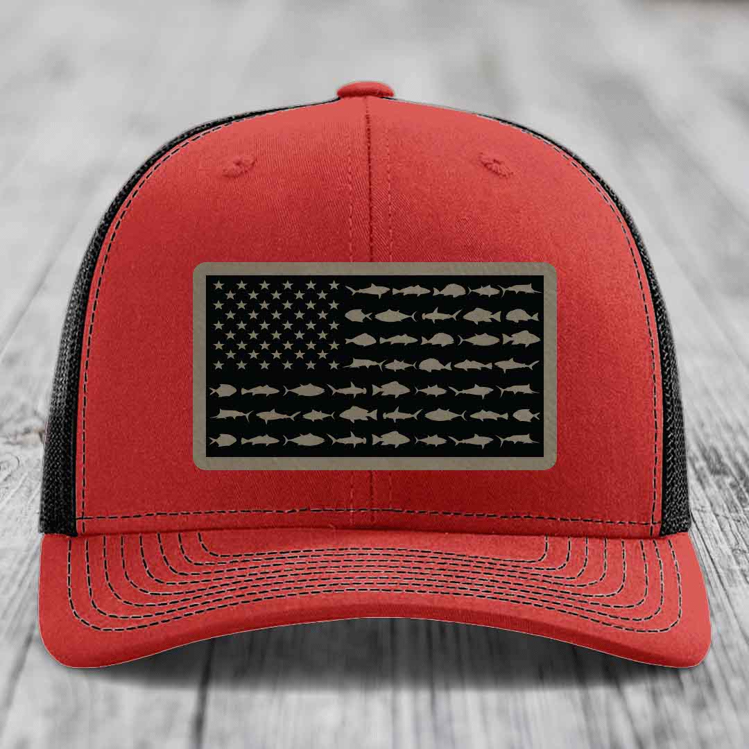 Red and black trucker hat with American flag patch featuring fish silhouettes instead of stars and stripes.