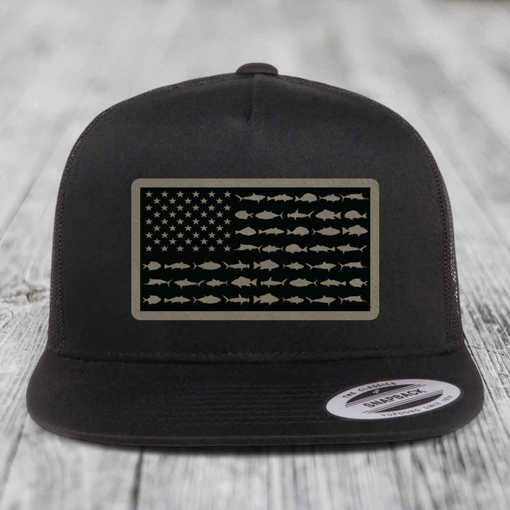 Black trucker hat with American flag patch made of saltwater fish silhouettes.