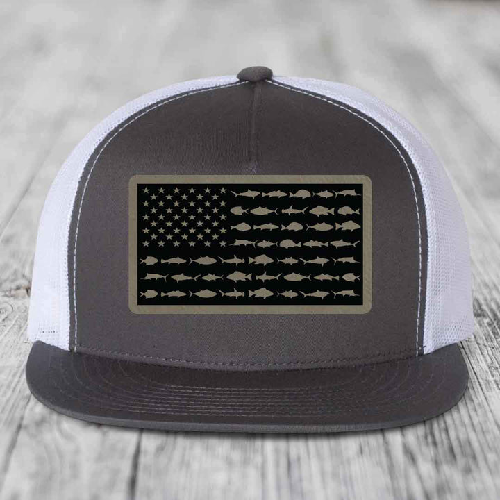 Black and white trucker hat with American flag patch made of saltwater fish silhouettes.