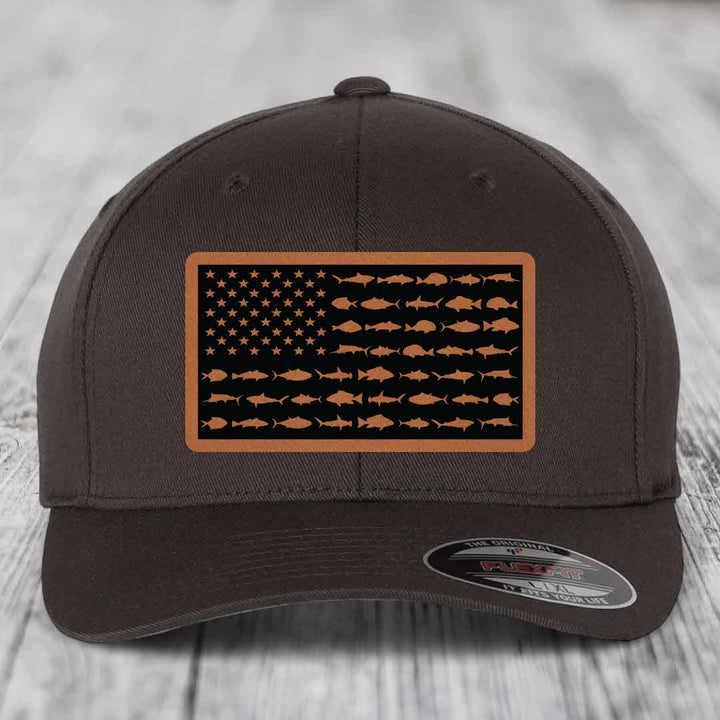 Dark brown baseball cap with American flag patch featuring fish silhouettes instead of stars and stripes.