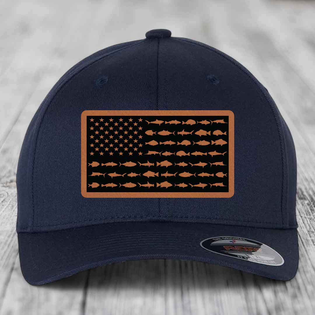 Dark blue baseball cap with a rectangular patch featuring an American flag design made of fish silhouettes in tan and black.