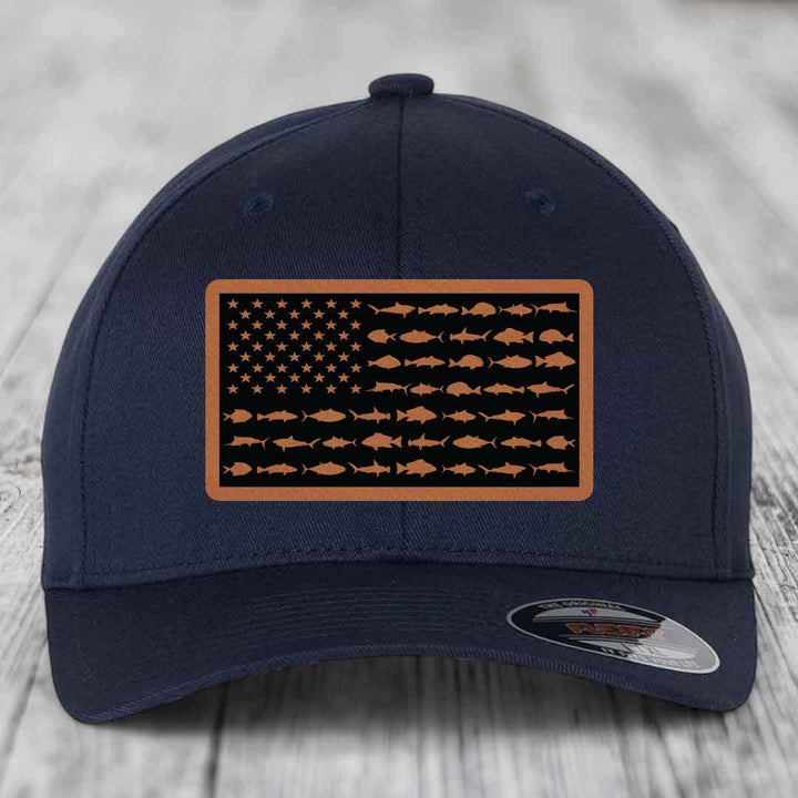 Dark blue baseball cap with a rectangular patch featuring an American flag design made of fish silhouettes in tan and black.