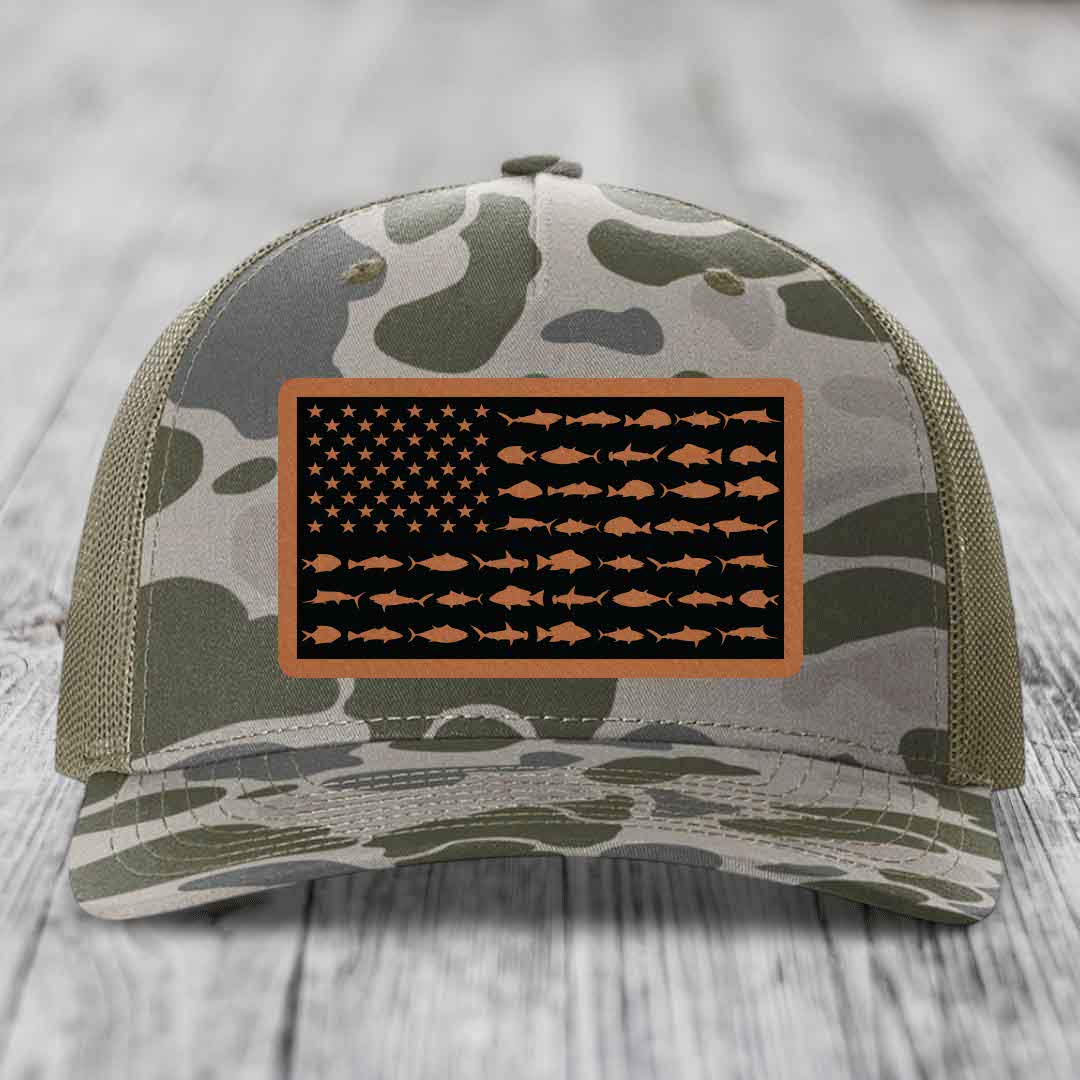 Camouflage trucker hat with American flag patch featuring fish silhouettes instead of stars and stripes.