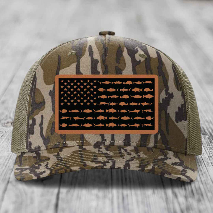 Camouflage trucker hat with American flag patch featuring fish silhouettes instead of stars and stripes.