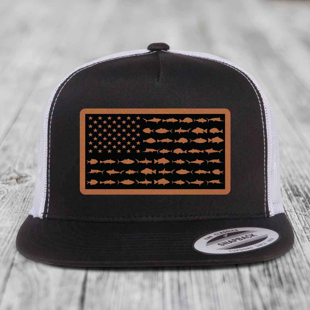 Black and white trucker hat with a brown leather patch featuring an American flag design made of fish silhouettes.