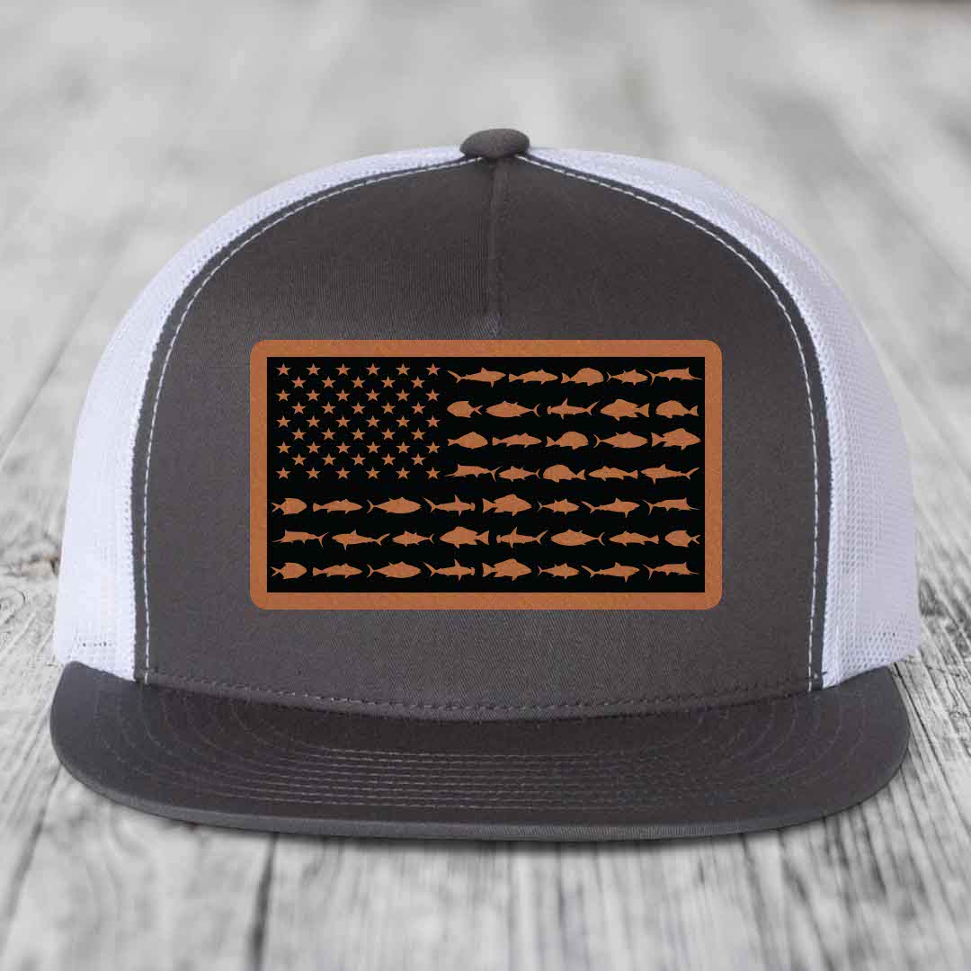 Grey and white trucker hat with American flag patch made of fish silhouettes in brown leatherette.