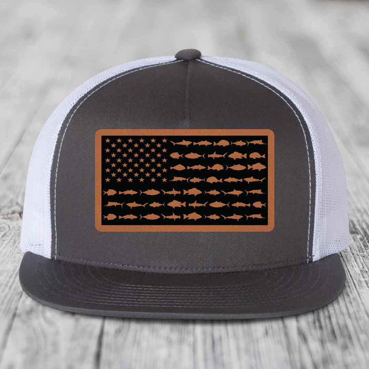 Grey and white trucker hat with American flag patch made of fish silhouettes in brown leatherette.