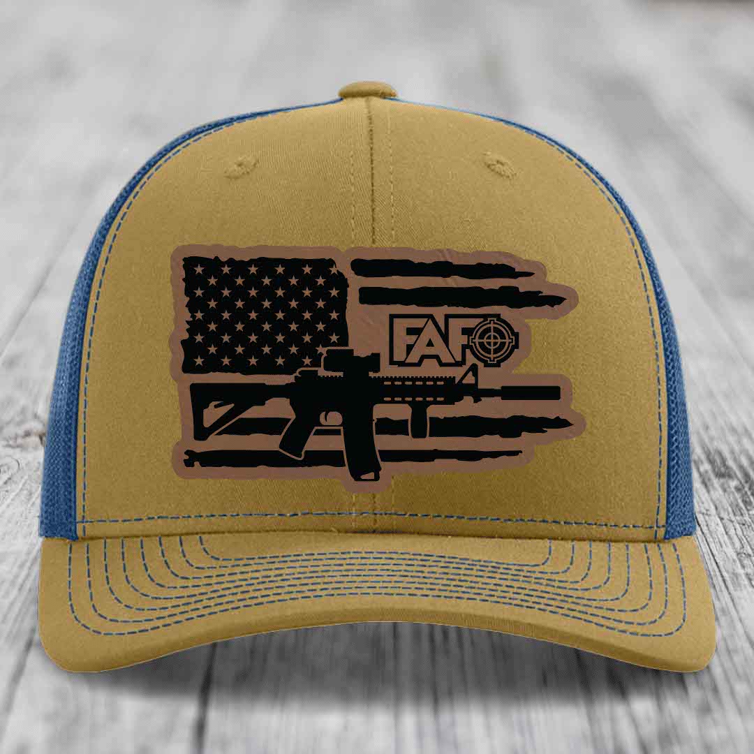 Tan and blue trucker hat with American flag patch featuring AR-15 and &