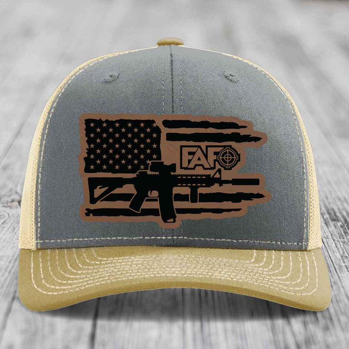 Grey and tan trucker hat with American flag patch featuring AR15 and FAFO logo.