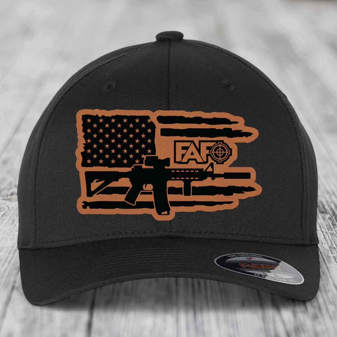 Black baseball cap with tan leather patch featuring American flag, AR-15 silhouette, and &
