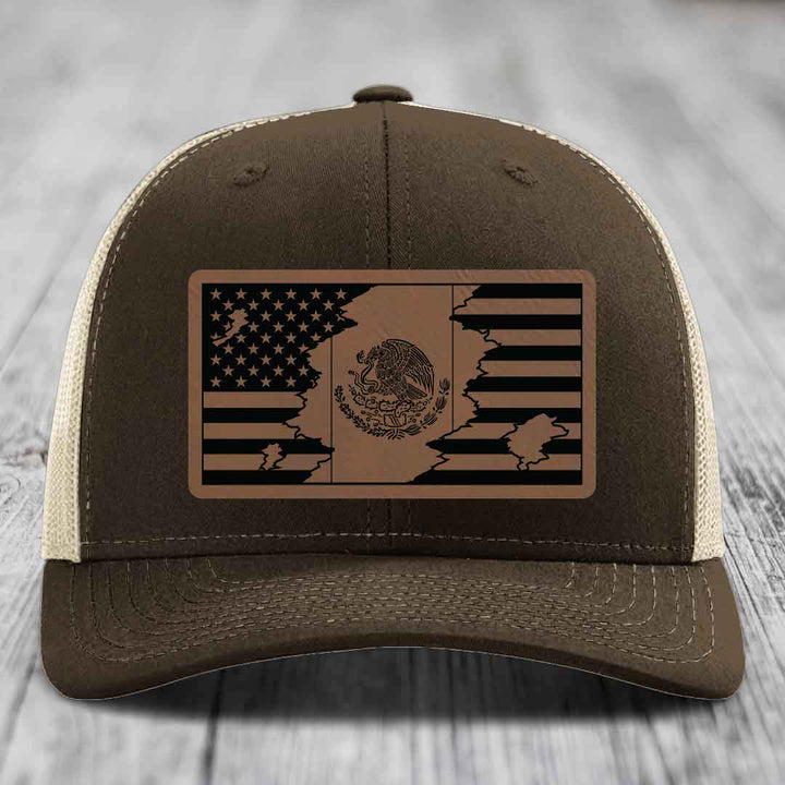 Brown trucker hat with a distressed American and Mexican flag leather patch on the front.
