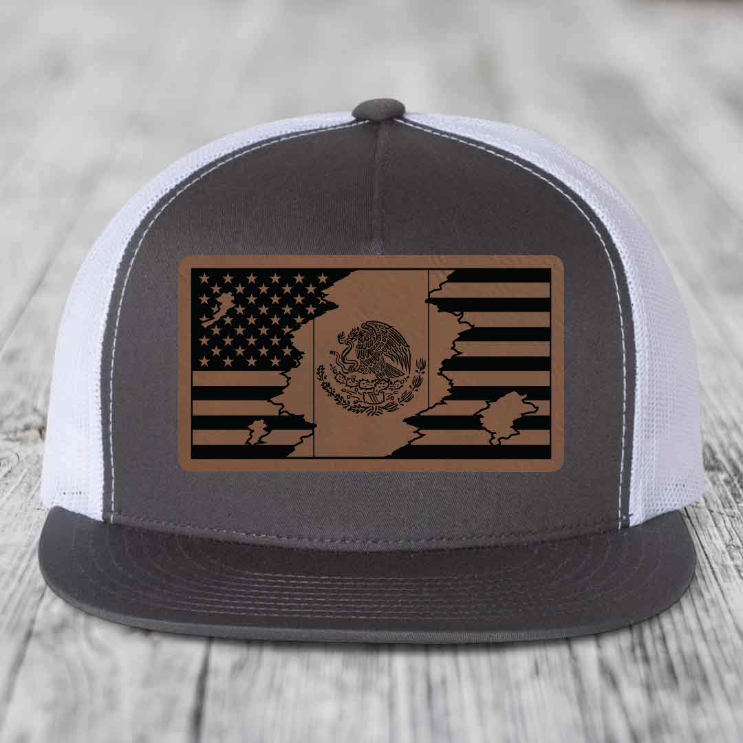 Grey and white trucker hat with a brown leather patch showing a split American and Mexican flag design.
