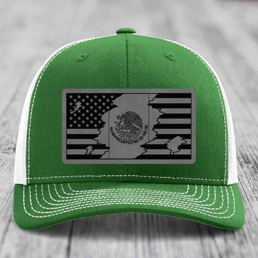 Green trucker hat with white mesh back and stitching, featuring a black and grey American-Mexican flag patch.