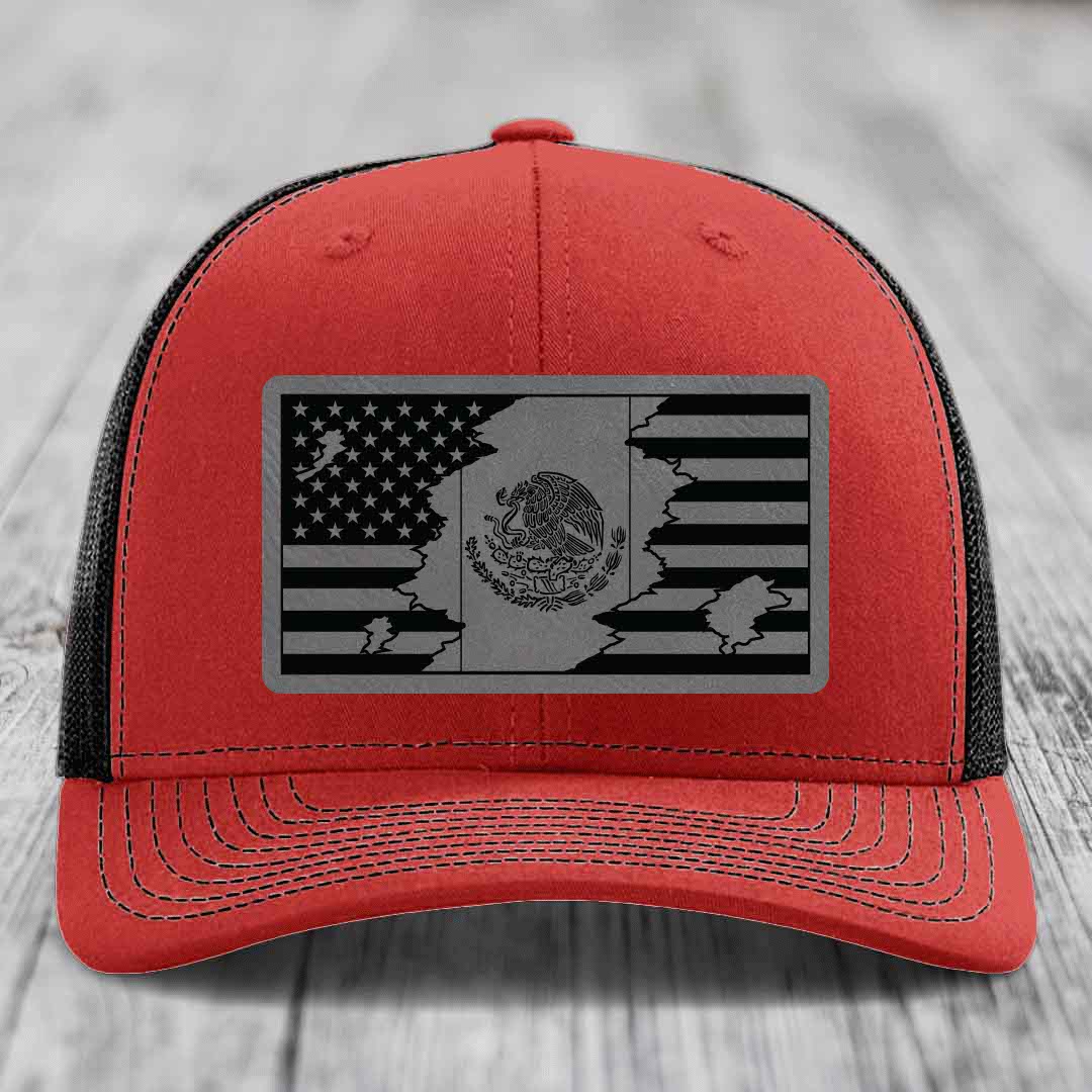 Red trucker hat with black mesh back and gray American-Mexican flag patch on front.