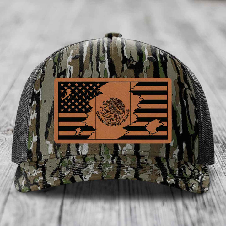 Camouflage trucker hat with a brown leather patch featuring the American and Mexican flags merged together.