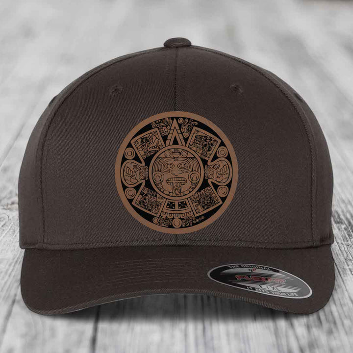Dark brown Flexfit hat with Aztec calendar leather patch on front.