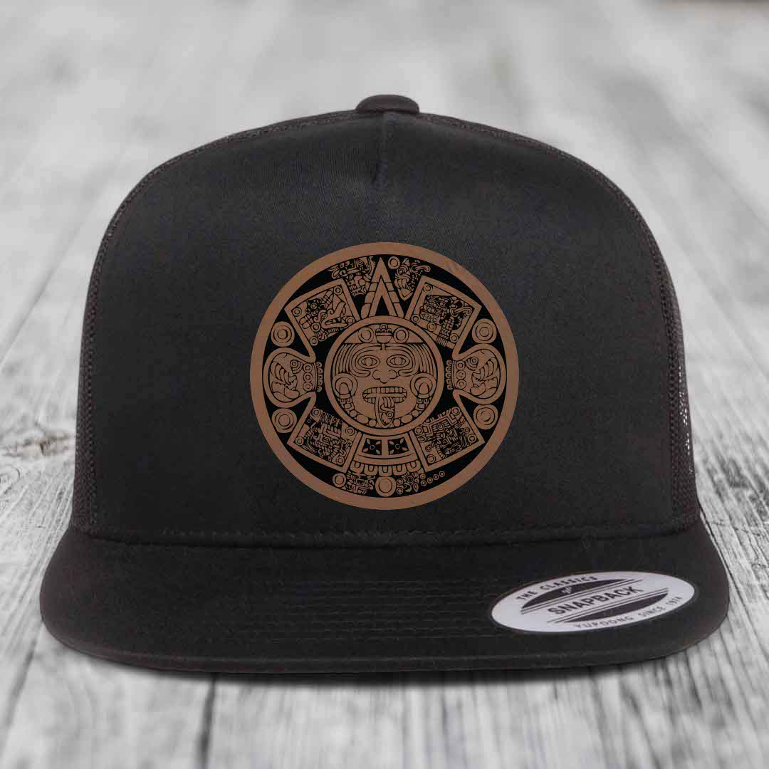 Black snapback hat with brown Aztec calendar leather patch on front.
