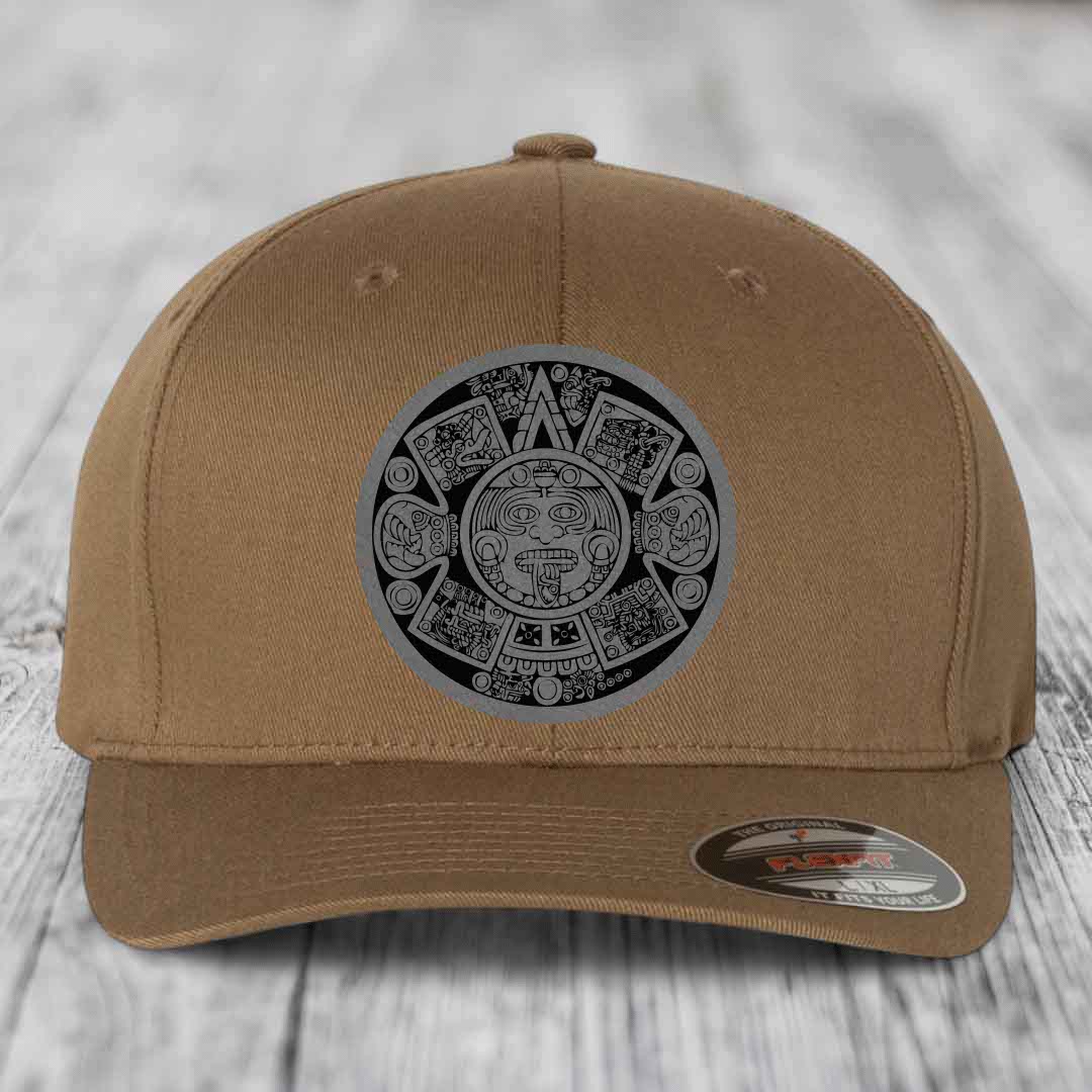 Tan baseball cap with Aztec calendar patch on front, featuring black and grey design.