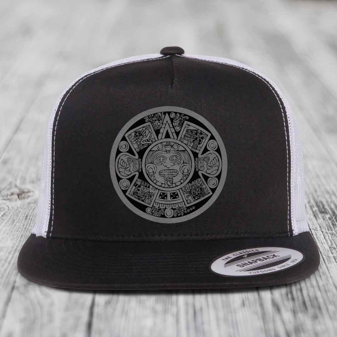 Black and white trucker hat with Aztec calendar design on front.